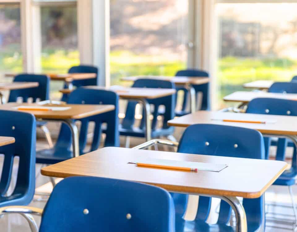 A row of desks in a clean classroom