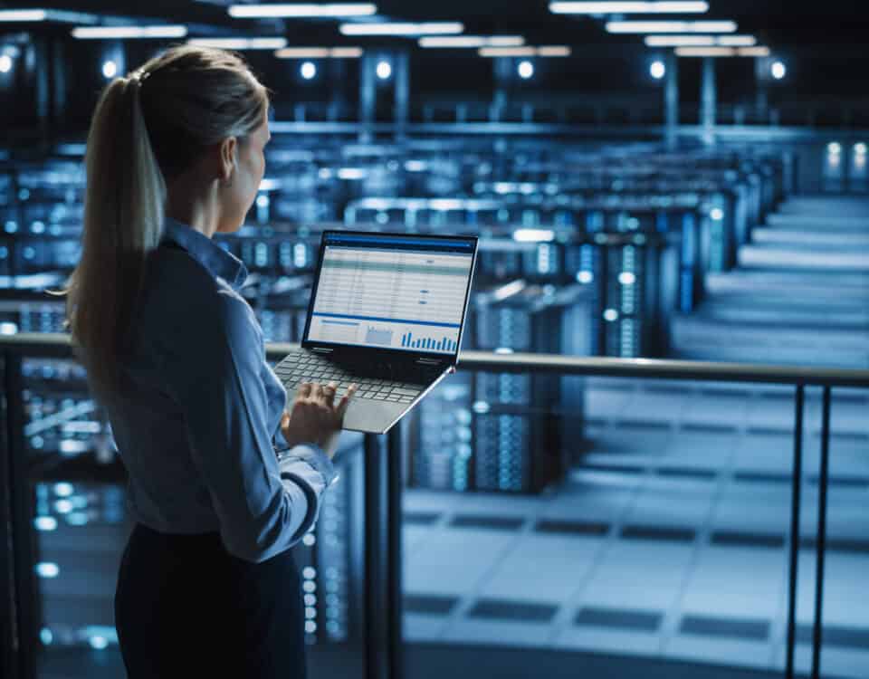 A woman standing in a large data center with cooling systems