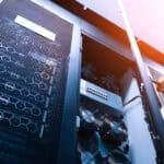 A detailed view of a server rack featuring cooling fans and network equipment