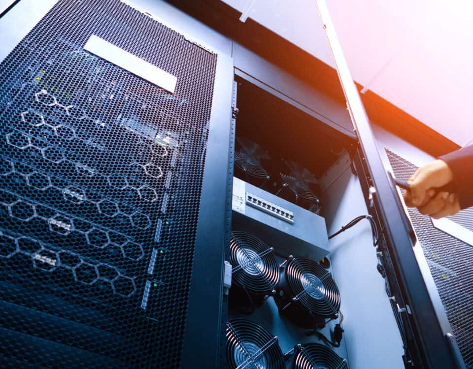 A detailed view of a server rack featuring cooling fans and network equipment