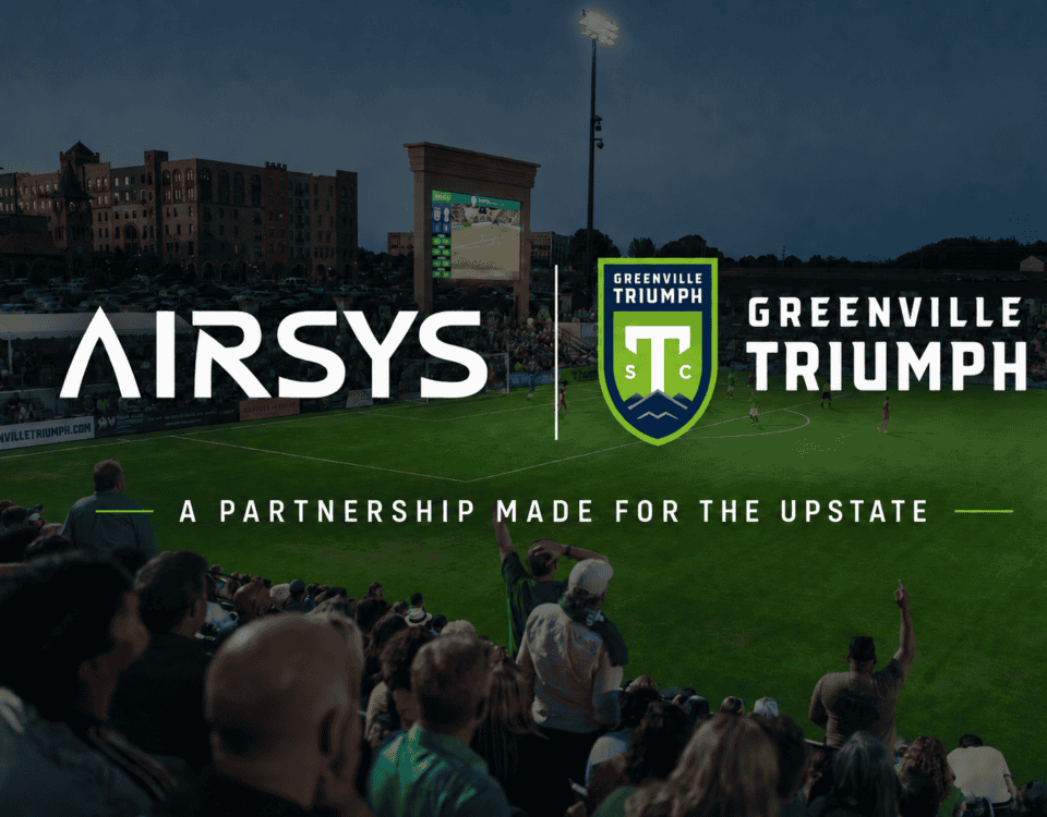 Co-branded graphic announcing the partnership between Airsys and Greenville Triumph. On a dark background, the white Airsys logo is placed on the left, and the green-and-yellow Greenville Triumph crest logo is on the right. Below the logos, green text reads: "A PARTNERSHIP MADE FOR THE UPSTATE" over a faint background photo of soccer stadium lights.